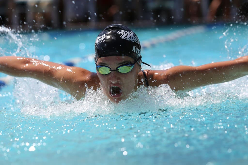 Competitive swimmer doing butterfly stroke in a pool